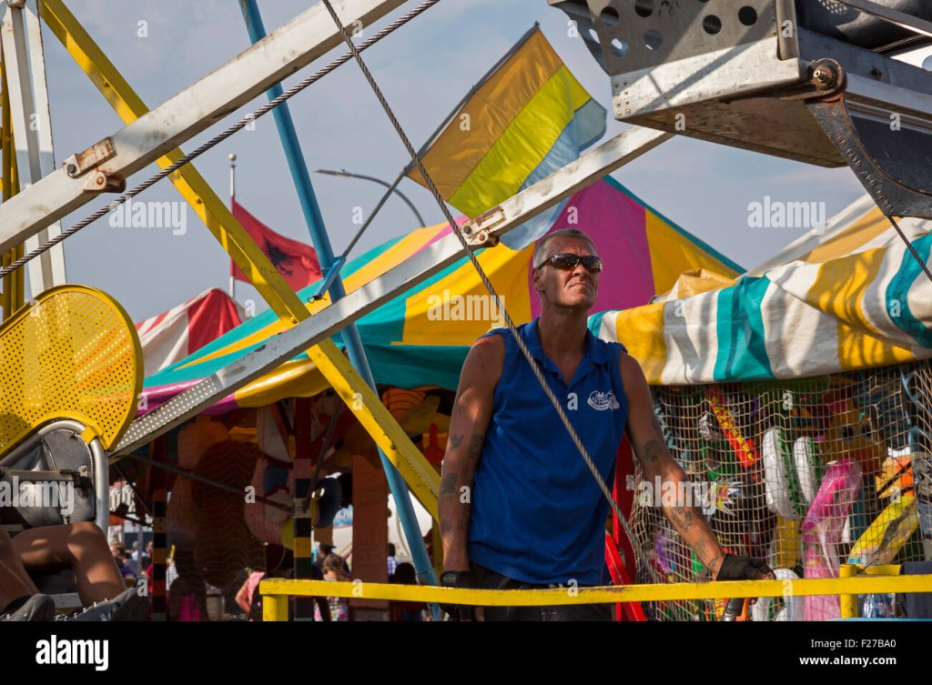 Picture of: Hamtramck, Michigan – A carnival worker operates a ferris wheel